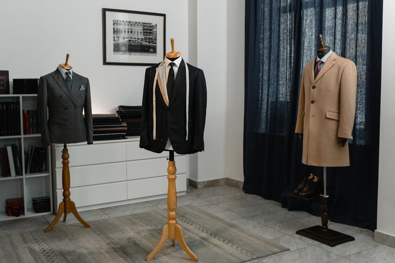 The Art of Drawing Readers In: Your attractive post title goes here Stylish men's suits on mannequins in an atelier, showcasing luxury tailoring.